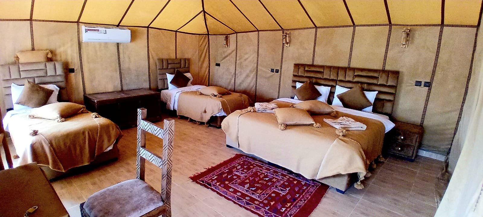 Private tent interior prepared for one guest in Merzouga